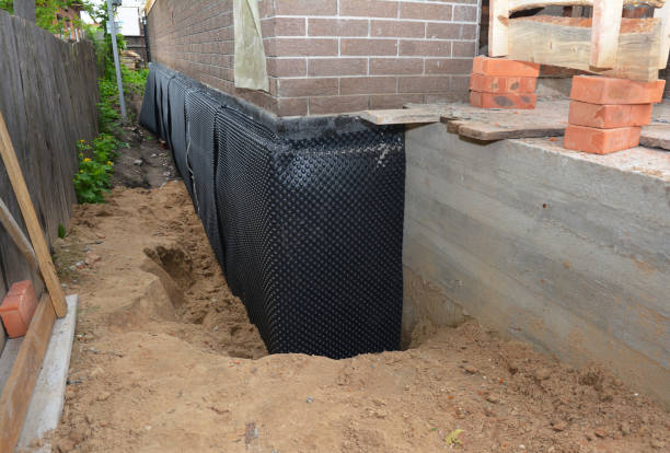Happy homeowners after waterproofing job in Dora